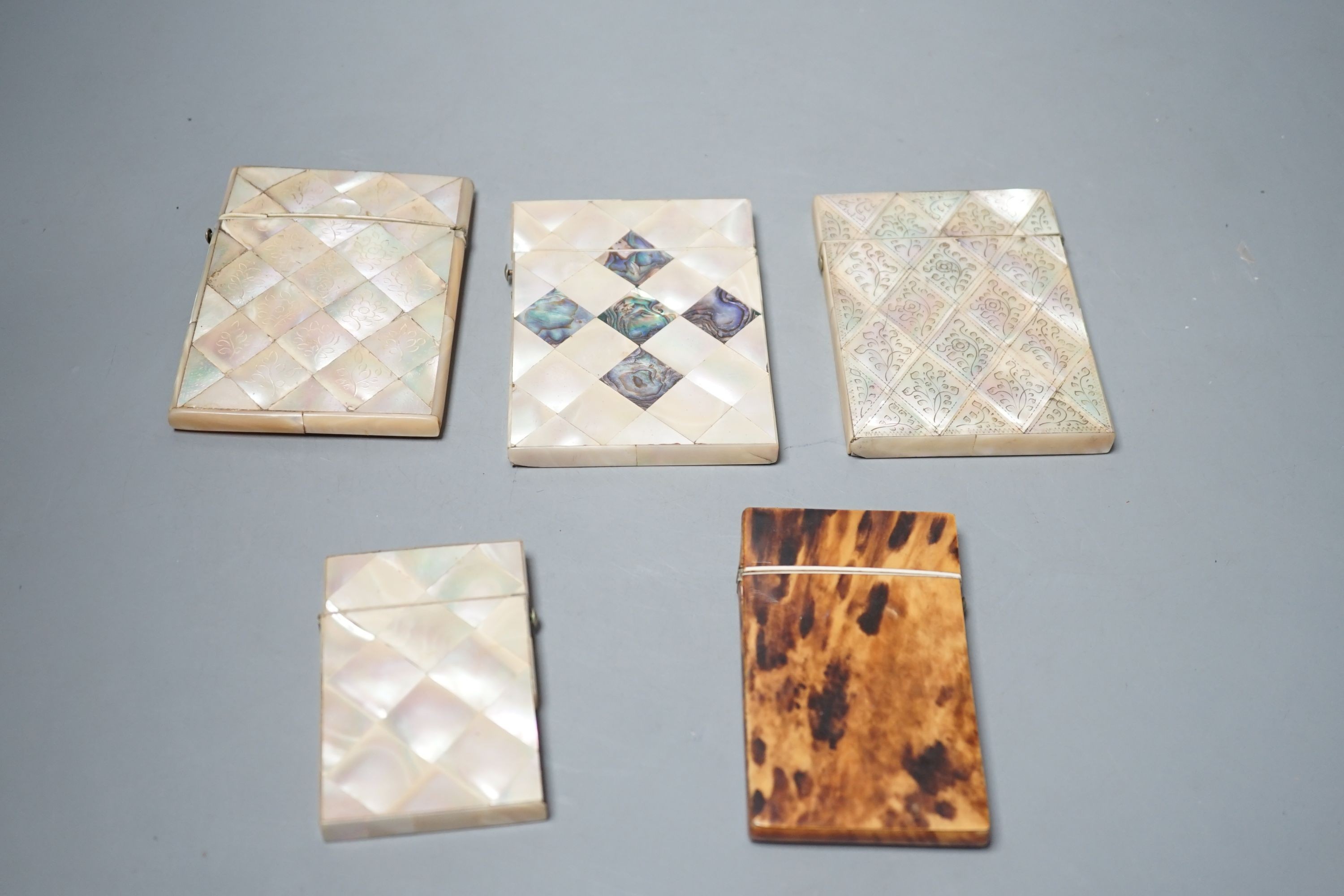 A selection of four mother of pearl card cases, together with another tortoiseshell card case inlaid with bone (5)